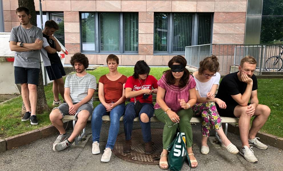 Listening exercise, participants sit and listen on a bench