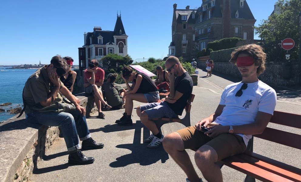 Listening exercise, participants sit on bench and listen